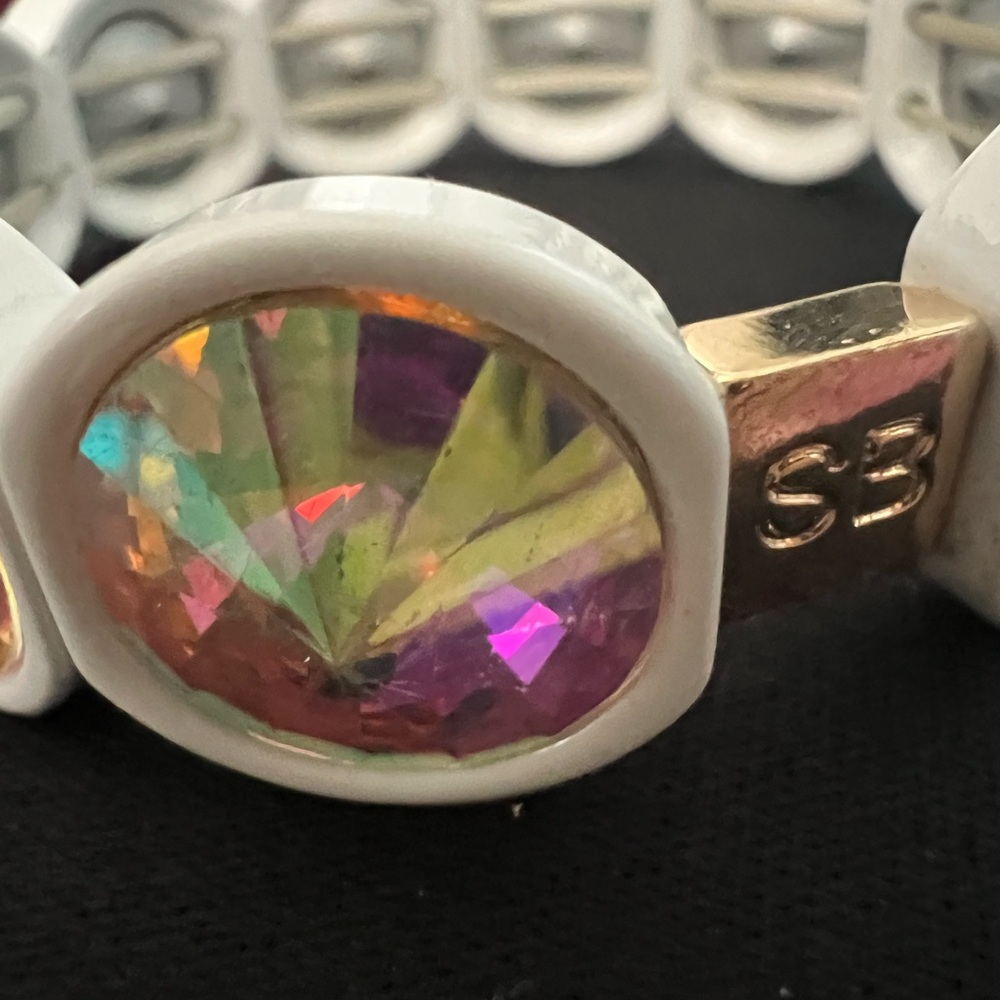“Shine Bright: Dazzling Aurora Borealis Bracelet with ‘SB’ Gold Accent”